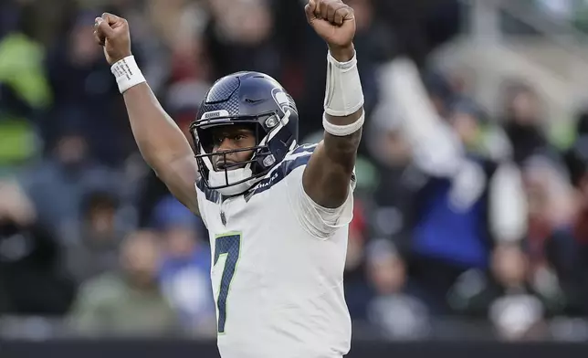 Seattle Seahawks quarterback Geno Smith (7) reacts after a touchdown by running back Zach Charbonnet during the fourth quarter of an NFL football game against the New York Jets, Sunday, Dec. 1, 2024, in East Rutherford, N.J. (AP Photo/Adam Hunger)