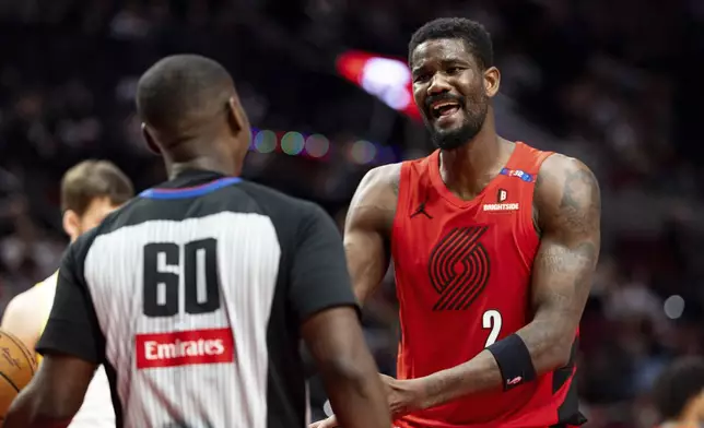 Portland Trail Blazers center Deandre Ayton, right, reacts after a foul call during the second half of an NBA basketball game against the Utah Jazz, Thursday, Dec. 26, 2024, in Portland, Ore. (AP Photo/Howard Lao)