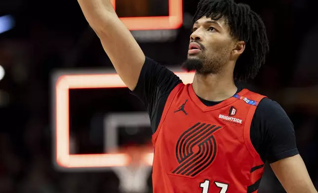 Portland Trail Blazers guard Shaedon Sharpe makes the buzzer beater against the Utah Jazz at the end of the first half of an NBA basketball game, Thursday, Dec. 26, 2024, in Portland, Ore. (AP Photo/Howard Lao)