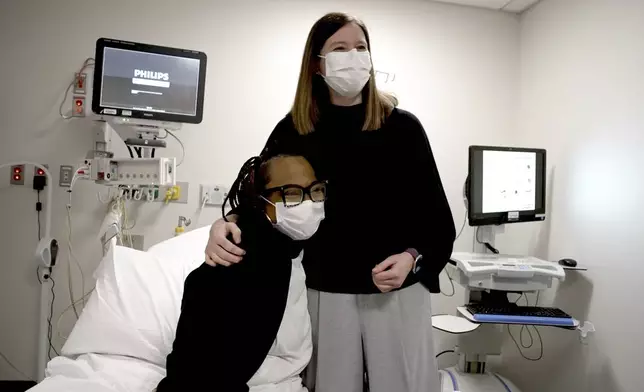 Pig kidney recipient Towana Looney sits with transplant surgeons Dr. Jayme Locke on Dec. 10, 2024, at NYU Langone Health, in New York City. (AP Photo/Shelby Lum)