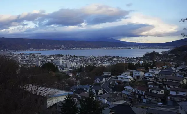 Lake Suwa overlooks Okaya, central Japan, Friday, Nov. 29, 2024. (AP Photo/Hiro Komae)