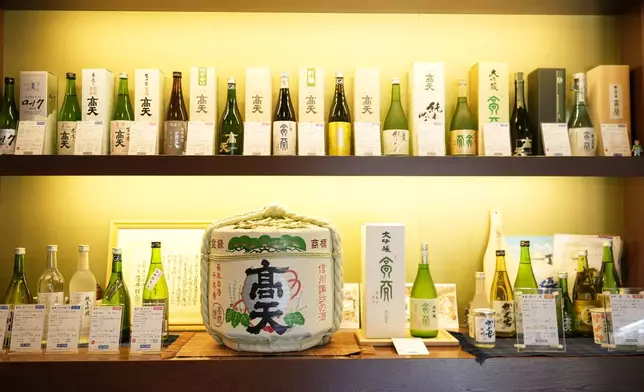 Bottles of Japanese sake brands made at the Koten brewery are displayed at the storefront in Okaya, central Japan, Saturday, Nov. 30, 2024. (AP Photo/Hiro Komae)