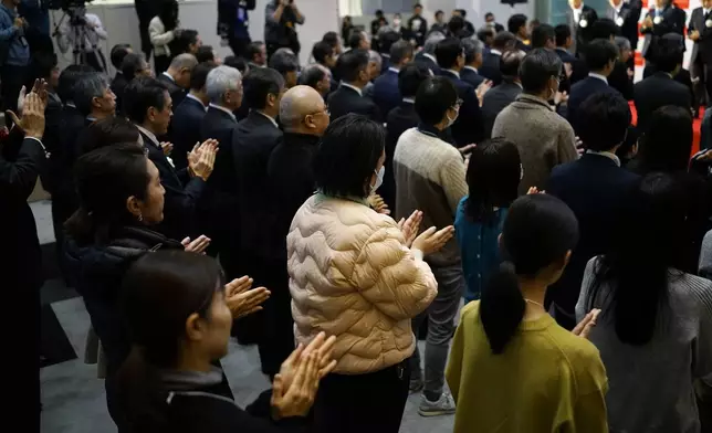 Participants perform a traditional hand clap at the end of a ceremony to conclude the year's trading at the Tokyo Stock Exchange Monday, Dec. 30, 2024, in Tokyo. (AP Photo/Eugene Hoshiko)