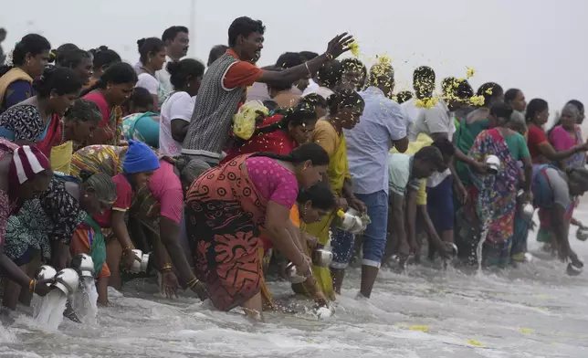 Indians offer tributes in remembrance of victims of the 2004 tsunami on the 20th anniversary of the tragedy, at Marina Beach in Chennai, India, Thursday, Dec. 26, 2024. (AP Photo/Mahesh Kumar A.)