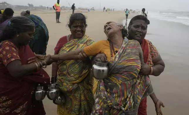 An Indian woman cries as she with others offer tributes in remembrance of victims of the 2004 tsunami on the 20th anniversary of the tragedy, at Marina Beach in Chennai, India, Thursday, Dec. 26, 2024. (AP Photo/Mahesh Kumar A.)