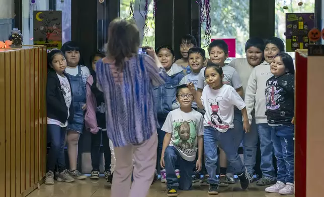 Second grade teacher Lori Spina taking a photo of her class for her newsletter Tuesday, Oct. 1, 2024, at Algodones Elementary School in Algodones, N.M. (AP Photo/Roberto E. Rosales)