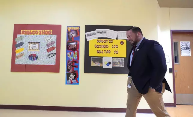 Rice Intermediate School Principal Nicholas Ferro walks to a classroom at Rice Intermediate School Tuesday, Aug. 27, 2024, in San Carlos, Ariz. (AP Photo/Ross D. Franklin)