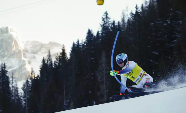 Norway's Timon Haugan speeds down the course during an alpine ski, men's World Cup slalom, in Alta Badia, Italy, Monday, Dec. 23, 2024. (AP Photo/Gabriele Facciotti)