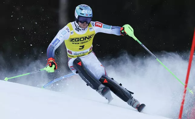 Norway's Timon Haugan speeds down the course during an alpine ski, men's World Cup slalom, in Alta Badia, Italy, Monday, Dec. 23, 2024. (AP Photo/Alessandro Trovati)