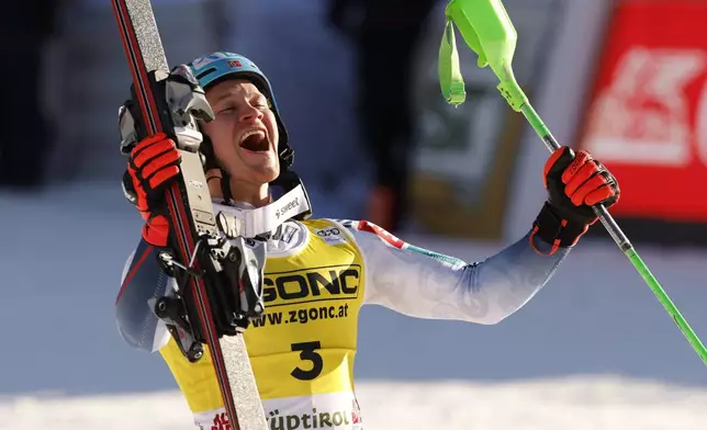 Norway's Timon Haugan celebrates at the finish area of an an alpine ski, men's World Cup slalom, in Alta Badia, Italy, Monday, Dec. 23, 2024. (AP Photo/Alessandro Trovati)