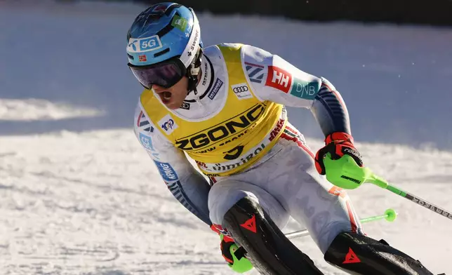 Norway's Timon Haugan celebrates at the finish area of an alpine ski, men's World Cup slalom, in Alta Badia, Italy, Monday, Dec. 23, 2024. (AP Photo/Alessandro Trovati)