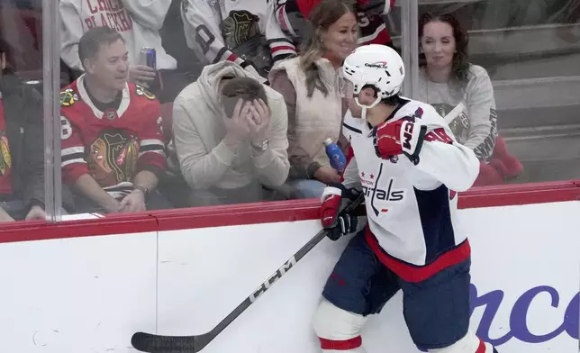 Washington Capitals' Andrew Mangiapane celebrates his gaol in front of fans during the first period of an NHL hockey game against the Chicago BlackhawksTuesday, Dec. 17, 2024, in Chicago. (AP Photo/Charles Rex Arbogast) on