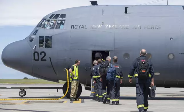 Members of the New Zealand Fire Service board a Royal New Zealand Air Force Hercules C130 H for a flight to Vanuatu, in Auckland, New Zealand, Wednesday, Dec. 18, 2024, following a magnitude 7.3 earthquake that struck just off the coast of Vanuatu in the South Pacific Ocean, Tuesday, Dec. 17. (SGT Maria Eves/New Zealand Defence Force via AP)