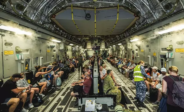 This photo released by Australian Department of Defence, shows Australian citizens on board a Royal Australian Air Force aircraft for a flight home from Bauerfield International Airport, Port Vila, Vanuatu, Wednesday, Dec. 18, 2024 following a powerful earthquake that struck just off the coast of Vanuatu in the South Pacific Ocean. (CPL Adam Abela/Australian Department of Defence via AP)