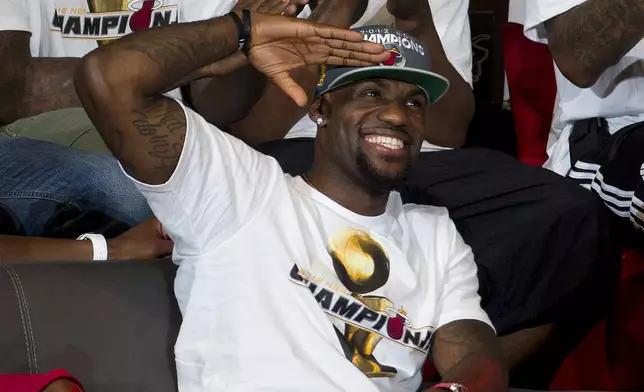 FILE - Miami Heat's LeBron James reacts to the crowd during a public celebration for the NBA Champions in Miami, on June 25, 2012. (AP Photo/J Pat Carter, File)