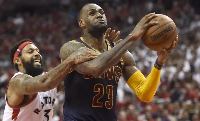 FILE - Toronto Raptors forward James Johnson fouls Cleveland Cavaliers forward LeBron James late in the fourth quarter of Game 6 of the NBA basketball Eastern Conference finals, on May 27, 2016, in Toronto. (Frank Gunn/The Canadian Press via AP, File)