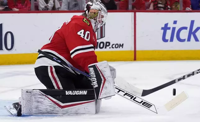 Chicago Blackhawks goaltender Arvid Soderblom stops a shot by New York Islanders left wing Anders Lee during the second period of an NHL hockey game in Chicago, Sunday, Dec. 15, 2024. (AP Photo/Nam Y. Huh)