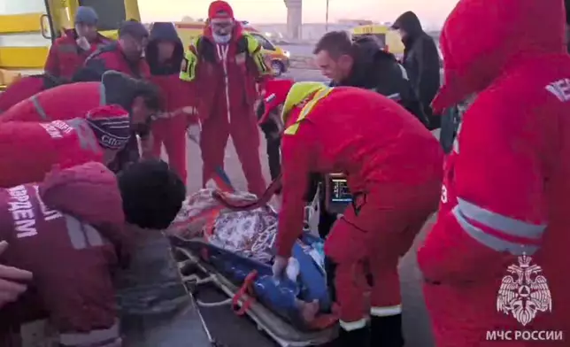 In this image released by the Russian Emergency Ministry Press Service, rescuers prepare to carry a wounded passenger near the Kazakhstani city of Aktau, Thursday, Dec. 26 , 2024, after a plane of Azerbaijani Airline crashed. (Russian Emergency Ministry Press Service via AP)