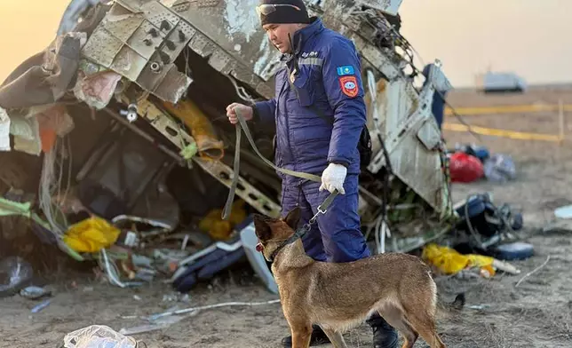 In this photo released by Kazakhstan's Emergency Ministry Press Service, rescuers work at the wreckage of Azerbaijan Airlines Embraer 190 lays on the ground near the airport of Aktau, Kazakhstan, Thursday, Dec. 26, 2024. (Kazakhstan's Emergency Ministry Press Service via AP)