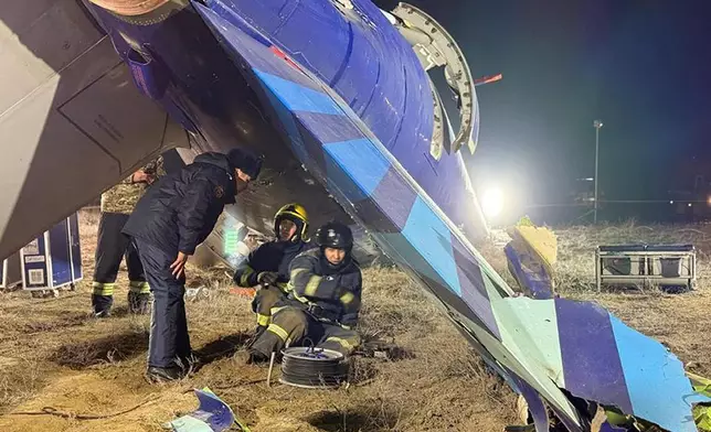 In this photo released by Kazakhstan's Emergency Ministry Press Service, rescuers work at the wreckage of Azerbaijan Airlines Embraer 190 lies on the ground near the airport of Aktau, Kazakhstan, Thursday, Dec. 26, 2024. (Kazakhstan's Emergency Ministry Press Service via AP)