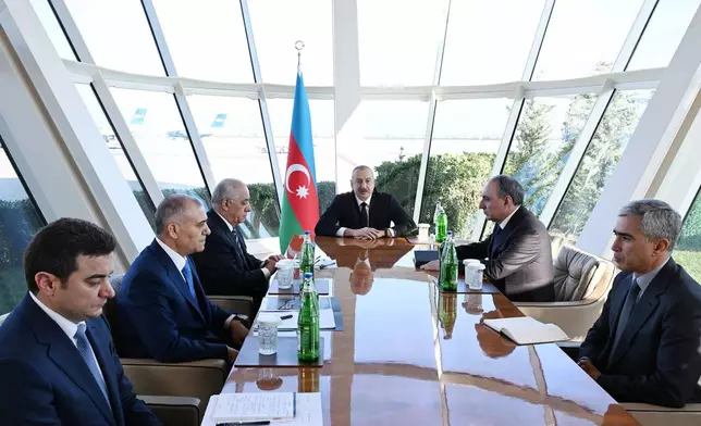 In this photo provided by Azerbaijan's Presidential Press Office, Azerbaijani President Ilham Aliyev, center, holds a meeting following an Azerbaijan Airlines Embraer 190 plane crash, in Baku, Wednesday, Dec. 25, 2024. (Azerbaijani Presidential Press Office via AP)