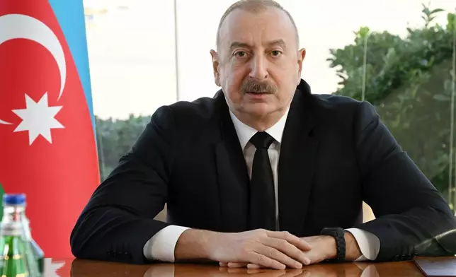 In this photo provided by Azerbaijan's Presidential Press Office, Azerbaijani President Ilham Aliyev holds a meeting in Baku, Wednesday, Dec. 25, 2024 following an Azerbaijan Airlines Embraer 190 plane crash. (Azerbaijani Presidential Press Office via AP)