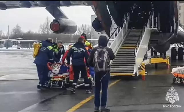 In this image taken from video released by the Russian Emergency Ministry Press Service, rescuers transport wounded passengers from a medical plane after the Azerbaijani Airline crashed, near the Kazakhstani city of Aktau, upon their arrival at the Zhukovsky airport outside Moscow, Russia, on Thursday, Dec. 26, 2024. (Russian Emergency Ministry Press Service via AP)