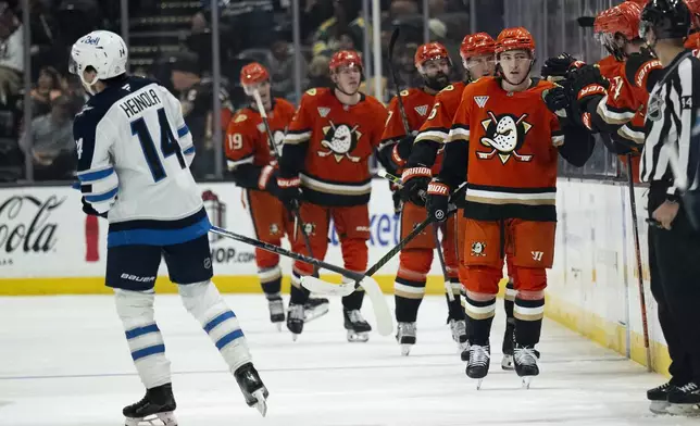 Anaheim Ducks right wing Frank Vatrano (77) celebrates his goal with the bench during the second period of an NHL hockey game against the Winnipeg Jets, Wednesday, Dec. 18, 2024, in Anaheim, Calif. (AP Photo/Kyusung Gong)