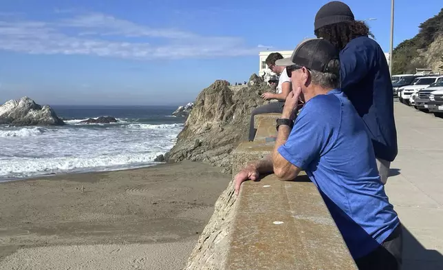 People watch the waves come in after an earthquake was felt widely across Northern California at Ocean Beach in San Francisco, Thursday, Dec. 5, 2024. (AP Photo/Haven Daley)