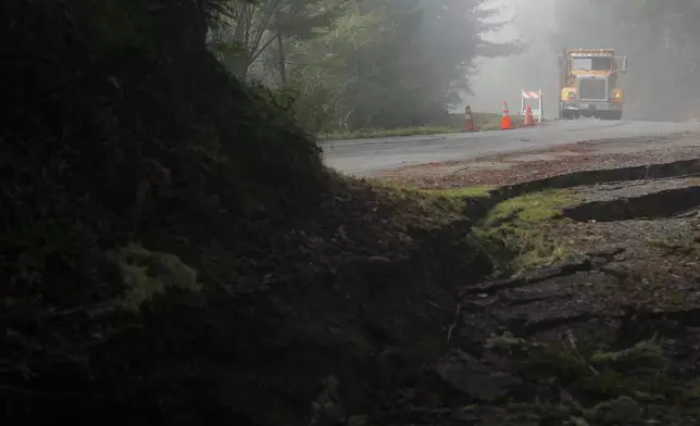 A crew with Humboldt County prepares to fill in cracks on the road caused by a 7.0 earthquake Friday, Dec. 6, 2024, in Humboldt County, Calif. (AP Photo/Godofredo A. Vásquez)