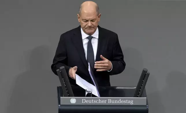 German Chancellor Olaf Scholz speaks during a plenary session at the German parliament Bundestag where he faces a vote of confidence, Berlin, Germany, Monday, Dec. 16, 2024. (AP Photo/Markus Schreiber)