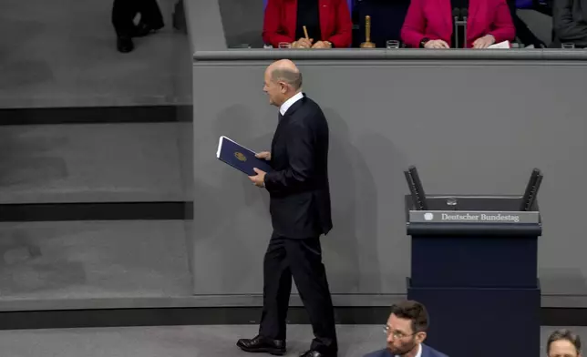 German Chancellor Olaf Scholz leaves after his speech during a plenary session at the German parliament Bundestag where he faces a vote of confidence, Berlin, Germany, Monday, Dec. 16, 2024. (AP Photo/Markus Schreiber)