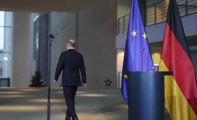 German Chancellor Olaf Scholz leaves after a statement after formally asking for a vote of confidence in parliament, to set the path for an early election in spring 2025, at the chancellery in Berlin, Germany, Wednesday, Dec. 11, 2024. (AP Photo/Markus Schreiber)