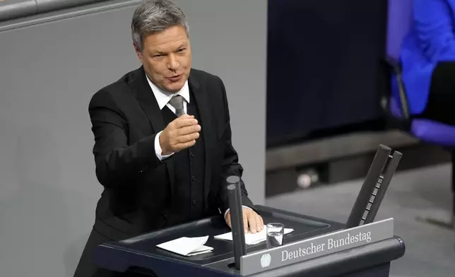 Economy and Climate Minister Robert Habeck speaks during a plenary session at the German parliament Bundestag where he faces a vote of confidence, Berlin, Germany, Monday, Dec. 16, 2024. (AP Photo/Markus Schreiber)