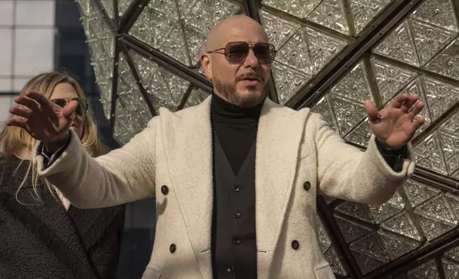 Singer Pitbull attends the Times Square New Year's Eve Ball Crystal Installation at One Times Square, Friday, Dec. 27, 2024, in New York. (AP Photo/Yuki Iwamura)