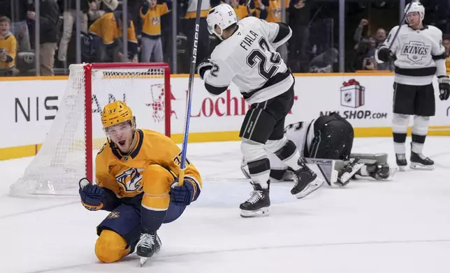 Nashville Predators defenseman Nick Blankenburg (37) celebrates his game winning goal against the Los Angeles Kings at the end of overtime of an NHL hockey game Saturday, Dec. 21, 2024, in Nashville, Tenn. The Predators won 3-2. (AP Photo/George Walker IV)