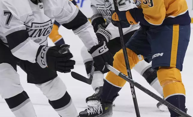 Nashville Predators defenseman Roman Josi (59) skates the puck past Los Angeles Kings defenseman Kyle Burroughs (7) during the second period of an NHL hockey game Saturday, Dec. 21, 2024, in Nashville, Tenn. (AP Photo/George Walker IV)