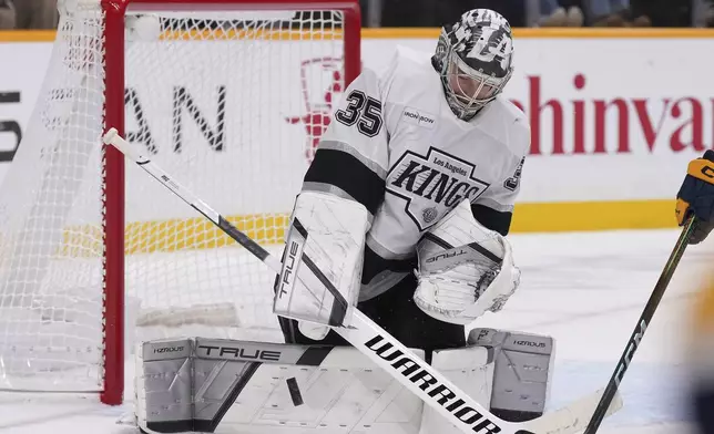 Los Angeles Kings goaltender Darcy Kuemper (35) blocks a shot on goal during the second period of an NHL hockey game against the Nashville Predators, Saturday, Dec. 21, 2024, in Nashville, Tenn. (AP Photo/George Walker IV)