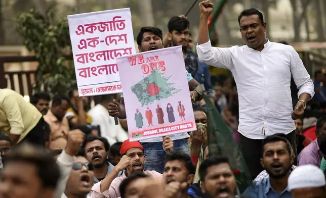 Supporters of Bangladesh's former Prime Minister Khaleda Zia and her Bangladesh Nationalist Party (BNP) shout slogans during an anti-India protest outside the Indian High Commission in Dhaka, Bangladesh Sunday, Dec. 8, 2024. A banner, rear, reads "One People, One Country, Bangladesh." (AP Photo/Mahmud Hossain Opu)