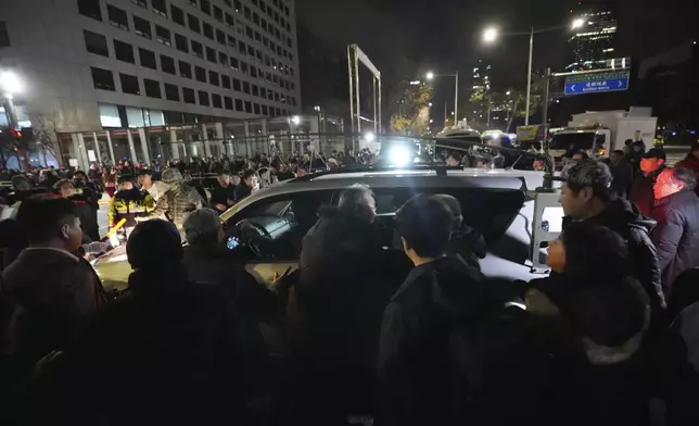 Military vehicles are surrounded by people outside the National Assembly in Seoul, South Korea, Wednesday, Dec. 4, 2024. (AP Photo/Lee Jin-man)