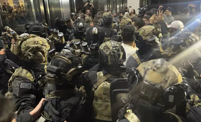 South Korean martial law soldiers try to enter the National Assembly compound in Seoul, South Korea, Wednesday, Dec. 4, 2024. (Cho Jung-woo/Newsis via AP)