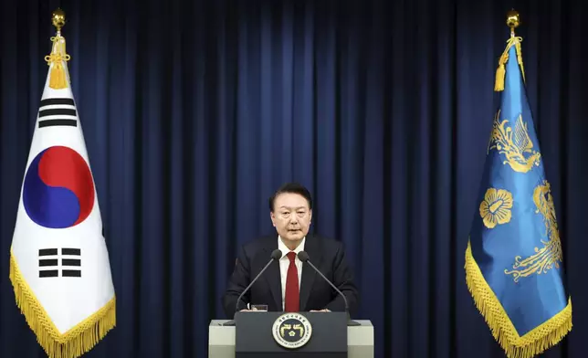 In this photo provided by South Korea Presidential Office, South Korean President Yoon Suk Yeol speaks during a press briefing at the presidential office in Seoul, South Korea, Tuesday, Dec. 3, 2024. (South Korea Unification Ministry via AP).