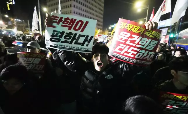 A man shouts to demand South Korean President Yoon Suk Yeol to step down in front of the National Assembly in Seoul, South Korea, Wednesday, Dec. 4, 2024. (AP Photo/Ahn Young-joon)