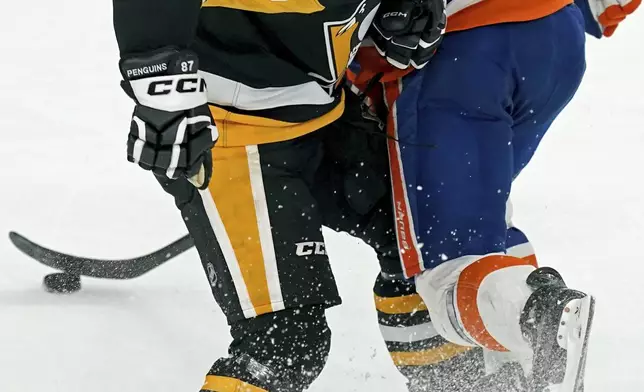 Pittsburgh Penguins' Sidney Crosby (87) collides with New York Islanders' Brock Nelson (29) during the first period of an NHL hockey game Sunday, Dec. 29, 2024, in Pittsburgh. (AP Photo/Matt Freed)