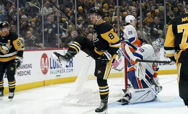 Pittsburgh Penguins' Michael Bunting (8) celebrates after scoring during the second period of an NHL hockey game against the New York Islanders, Sunday, Dec. 29, 2024, in Pittsburgh. (AP Photo/Matt Freed)