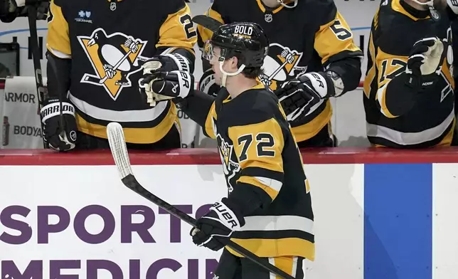 Pittsburgh Penguins' Anthony Beauvillier (72) returns to the bench after scoring during the first period of an NHL hockey game against New York Islanders, Sunday, Dec. 29, 2024, in Pittsburgh. (AP Photo/Matt Freed)