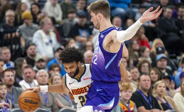 Denver Nuggets forward Spencer Jones. Left, tries to get by Utah Jazz forward Kyle Filipowski, right, during the first half of an NBA basketball game, Monday, Dec. 30, 2024, in Salt Lake City. (AP Photo/Rick Egan)