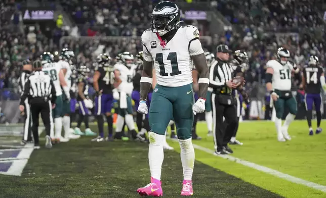 Philadelphia Eagles wide receiver A.J. Brown (11) reacts after teammate quarterback Jalen Hurts scored on a run against the Baltimore Ravens during the first half of an NFL football game, Sunday, Dec. 1, 2024, in Baltimore. (AP Photo/Stephanie Scarbrough)