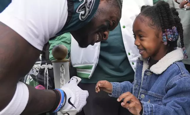 Philadelphia Eagles wide receiver A.J. Brown talks to his daughter Jersee before an NFL football game against the Carolina Panthers on Sunday, Dec. 8, 2024, in Philadelphia. (AP Photo/Chris Szagola)