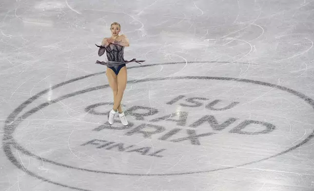 Amber Glenn, of the United States, competes in the women's free skating segment at the ISU Grand Prix Finals of Figure Skating, Saturday, Dec. 7, 2024, in Grenoble, France. (AP Photo/Laurent Cipriani)